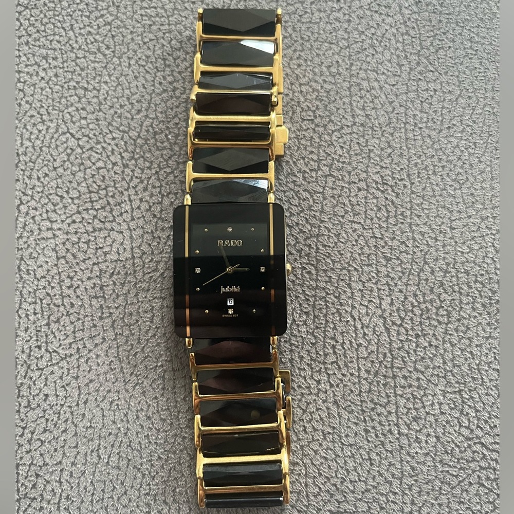 Black and gold rado watch